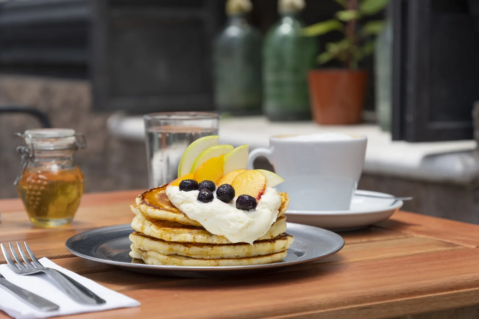 Pancakes and coffee on a cafe table. The photo was not taken at a Horizon West restaurant.