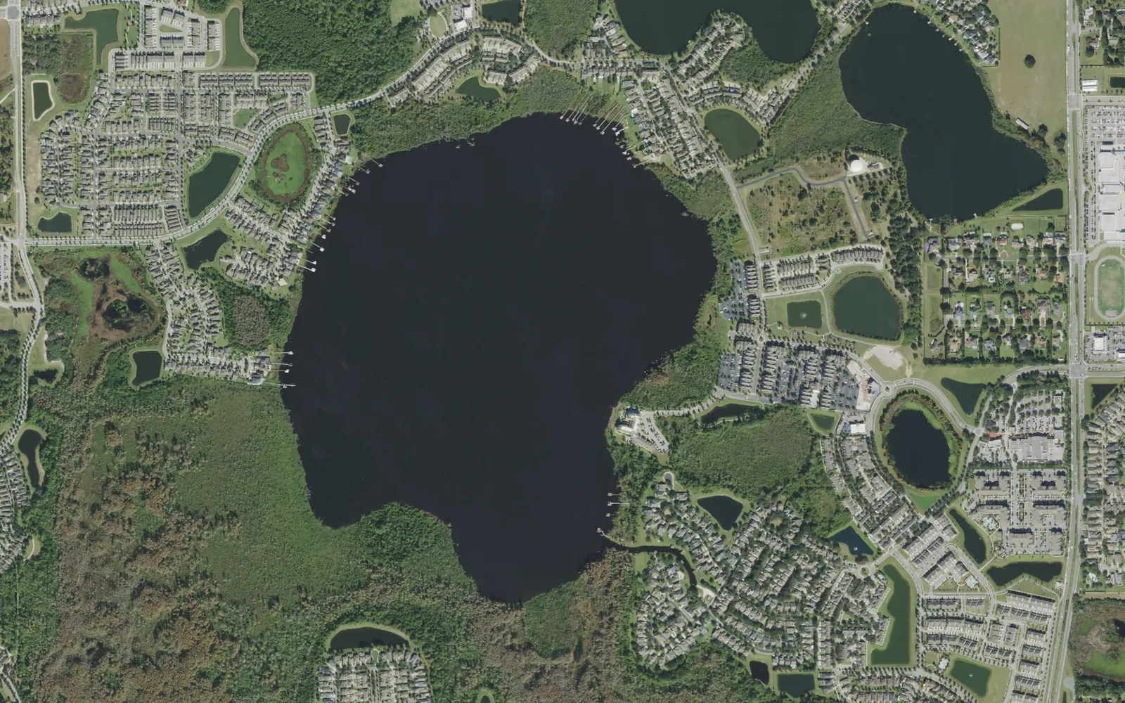 Aerial view of Lake Speer and the homes around it in the Village of Bridgewater, with Windermere High School at the right edge
