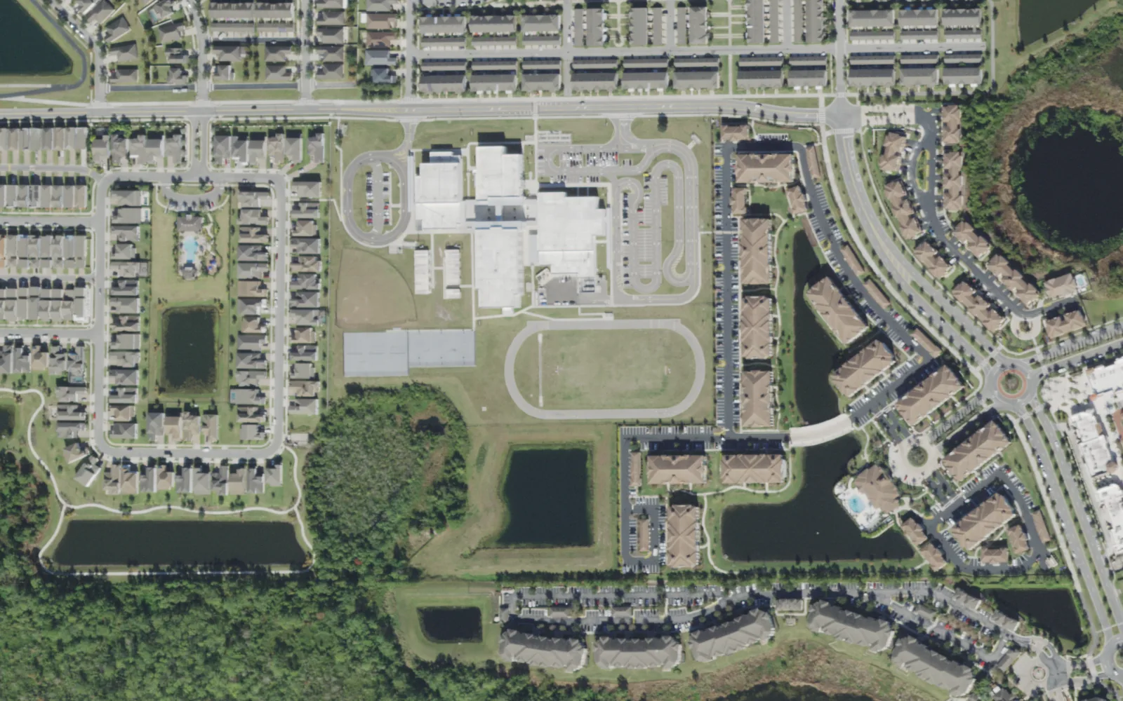 Horizon West Middle School on Tattant Boulevard in Lakeside Village, seen from the air, with homes and apartments around it