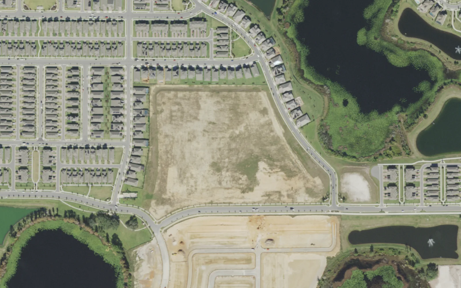 The Atwater Bay Elementary site, then a cleared lot among new homes, seen from the air in December 2021, before the school was built