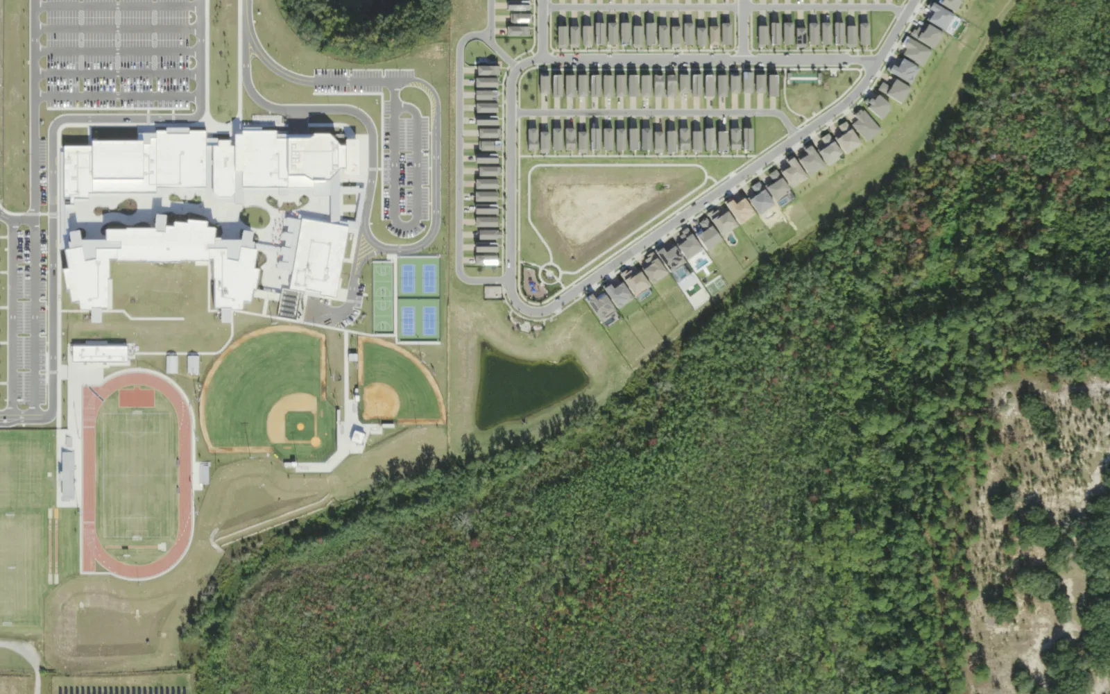 Horizon High School's buildings, ball fields and track off Seidel Road in Horizon West, seen from the air, with new homes to the north