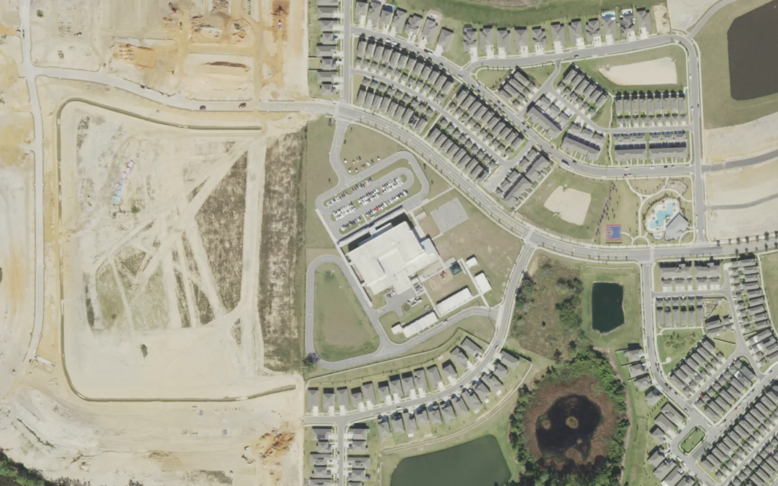 Water Spring Elementary School on Water Spring Boulevard, seen from the air in December 2021, with the Water Spring Middle site being cleared to the west