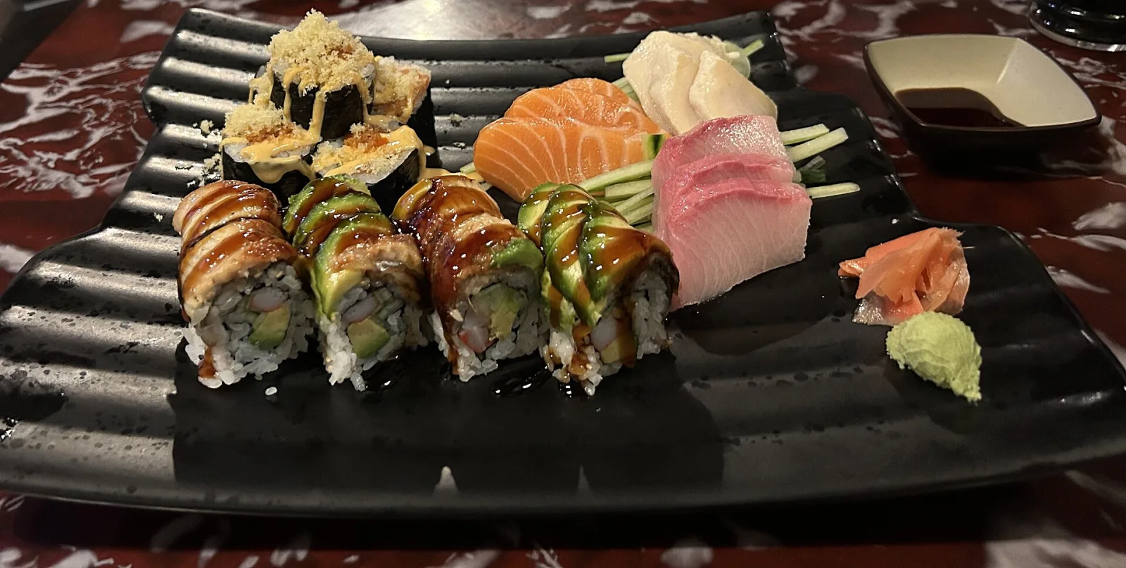 A plate of sushi rolls and sashimi with ginger and wasabi. The photo was not taken at a Horizon West restaurant.